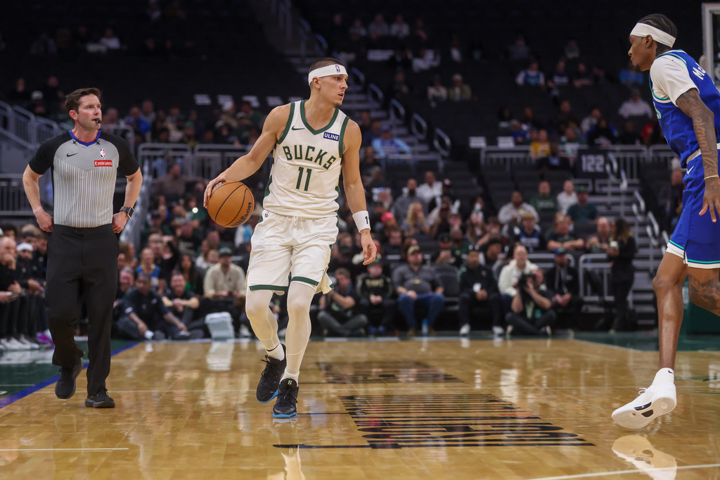 Milwaukee Bucks' guard Tyler Herro, left, brings the ball up the court against Minnesota Timberwolves forward Jaden McDaniels', right, during a preseason NBA basketball game Monday, Oct. 5, 2026, in Milwaukee. (AP Photo/Kylie Bridenhagen)