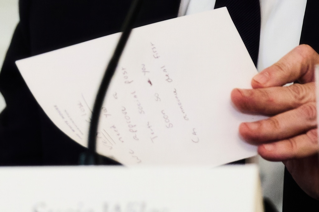 Secretary of State Marco Rubio writes a note before handing it to President Donald Trump during a roundtable meeting on antifa in the State Dining Room at the White House, Wednesday, Oct. 8, 2025, in Washington. (AP Photo/Evan Vucci)