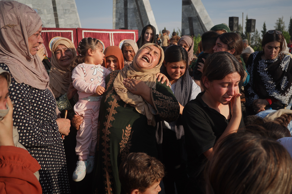 Women mourn during a mass funeral for prisoners who died in a fire that broke out during unrest at the local prison in the predominantly Kurdish city of Kobani, northern Syria, Monday, Sept. 14, 2026. (AP Photo/Baderkhan Ahmad)