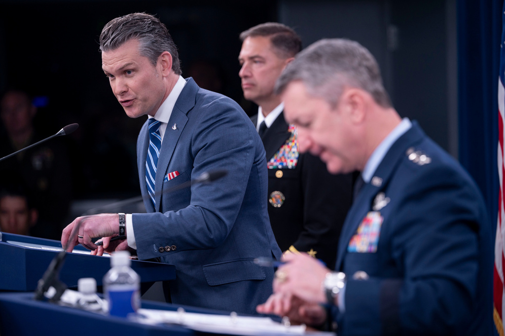 Defense Secretary Pete Hegseth speaks to members of the media during a press briefing with Adm. Brad Cooper, center, and Chairman of the Joint Chiefs of Staff Gen. Dan Caine, right, at the Pentagon, Thursday, April 16, 2026 in Washington. (AP Photo/Kevin Wolf)