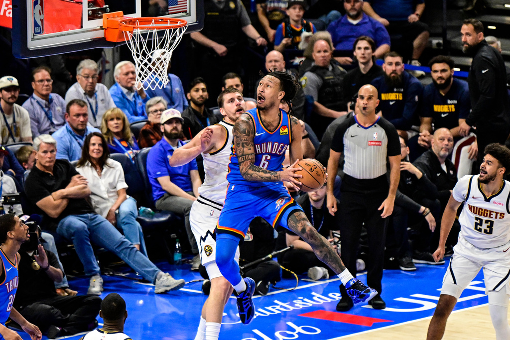 Oklahoma City Thunder forward Jaylin Williams (6) shoots against Denver Nuggets center Nikola Jokić (15) during the first half of an NBA basketball game Monday, March, 9 2026, in Oklahoma City. (AP Photo/Gerald Leong)