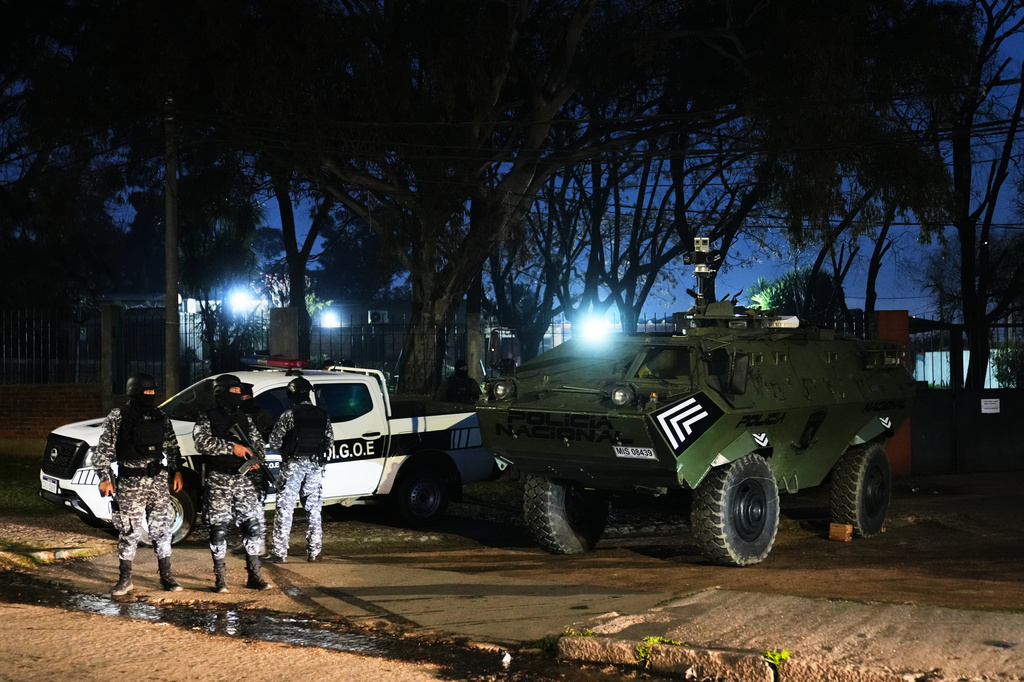 Police patrol by a U.S. donated Mamba armored military vehicle in the Marconi neighborhood of Montevideo, Uruguay, Sunday, July 26, 2026. (AP Photo/Matilde Campodonico)
