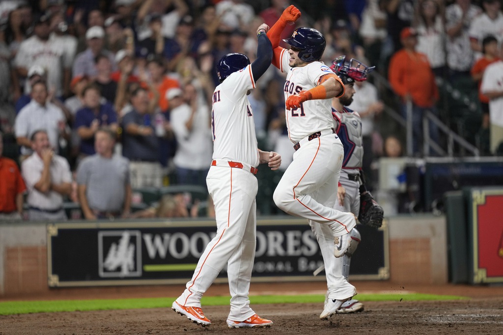 Houston Astros' Yainer Diaz (21) celebrates with Victor Caratini after hitting a two-run home run against the Boston Red Sox during the sixth inning of a baseball game Wednesday, Aug. 13, 2025, in Houston. (AP Photo/David J. Phillip)