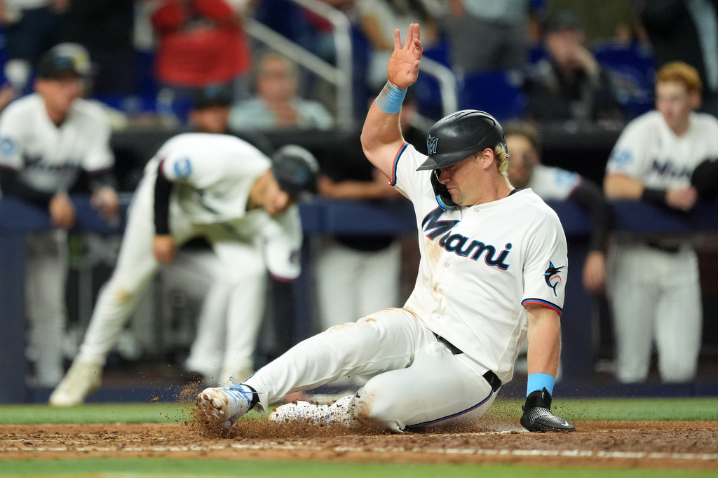 Miami Marlins' Kyle Stowers slides home to score on a double by Otto Lopez during the sixth inning of a baseball game against the St. Louis Cardinals, Monday, April 20, 2026, in Miami. (AP Photo/Rebecca Blackwell)