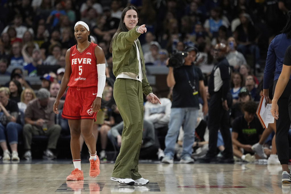 Indiana Fever guard Caitlin Clark (22), middle, points during the second half of a WNBA basketball game against the Minnesota Lynx, Sunday, Aug. 24, 2025, in Minneapolis. (AP Photo/Abbie Parr)