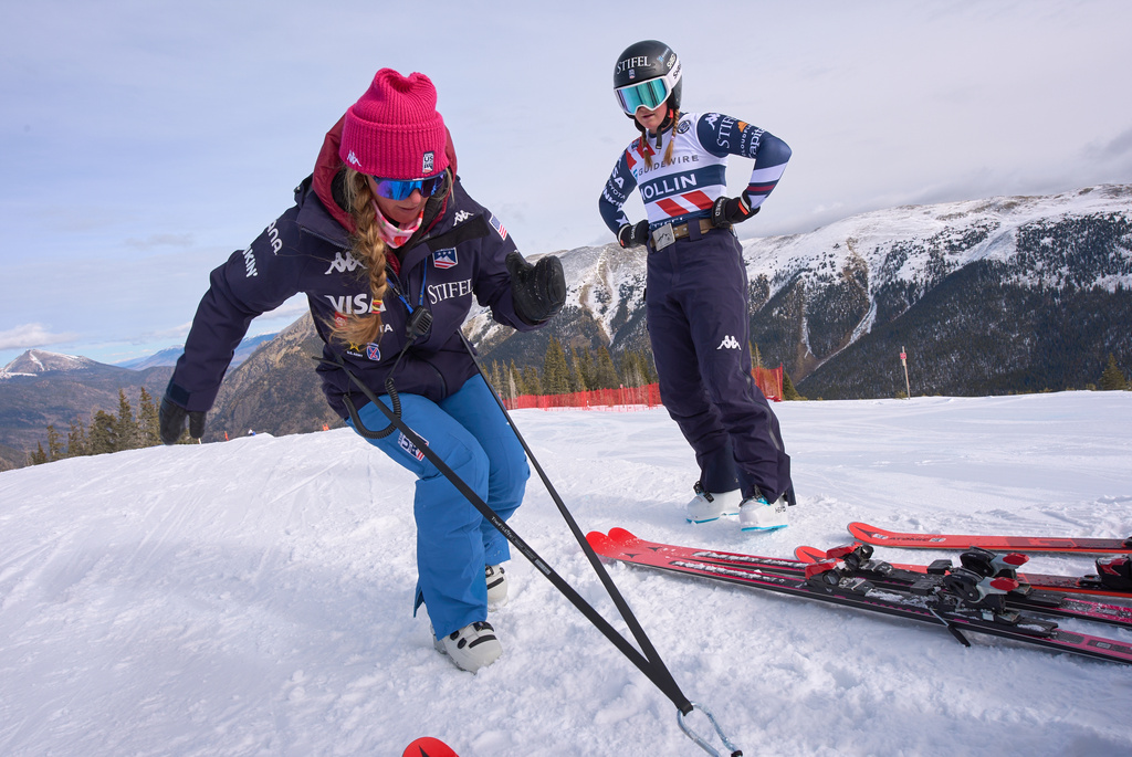 Skier Allison Mollin, right, watches as Foreste Peterson, a strength coach, demonstrates an exercise during U.S. Women's Ski Team practice in Copper Mountain, Colo., Nov. 20, 2025. (AP Photo/Jacquelyn Martin)