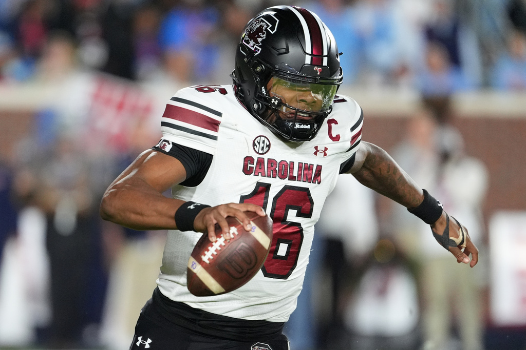 South Carolina quarterback Lanorris Sellers (16) evades a tackle attempt by the Mississippi defense during the first half of an NCAA college football game Saturday Nov. 1, 2025, in Oxford, Miss. (AP Photo/Rogelio V. Solis)