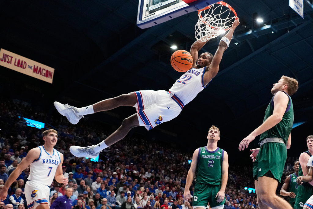 Kansas guard Darryn Peterson dunks the ball during the first half of an NCAA college basketball game against the Green Bay, Monday, Nov. 3, 2025, in Lawrence, Kan. (AP Photo/Charlie Riedel)