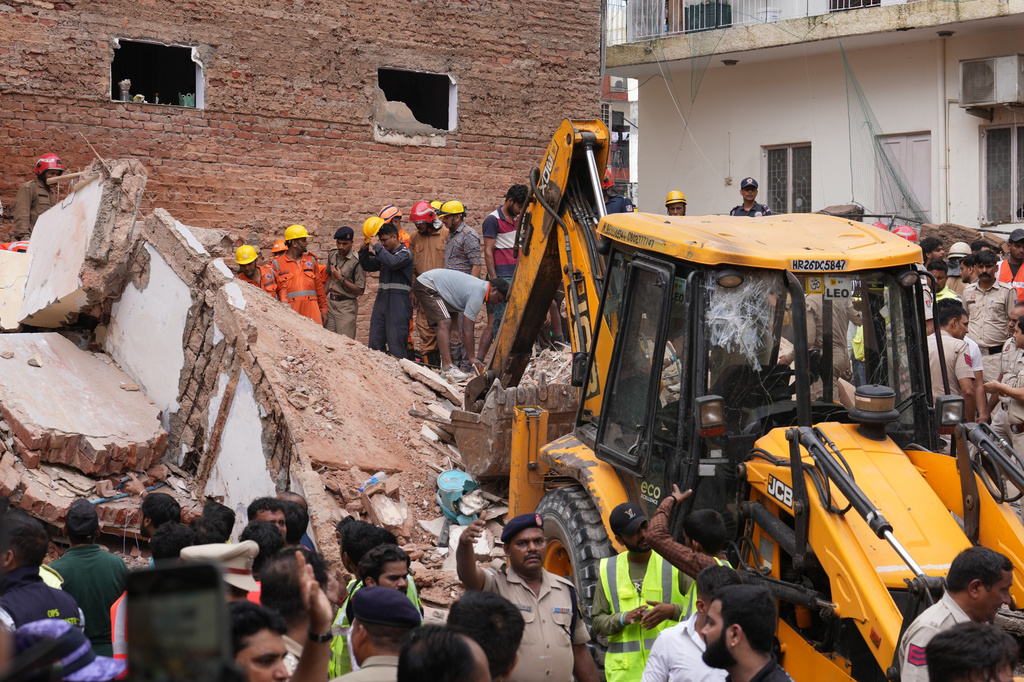 Rescue workers search for survivors under the rubble of a collapsed building in New Delhi, India, Sunday, Sept. 6, 2026. (AP Photo/Rajesh Kumar Singh)