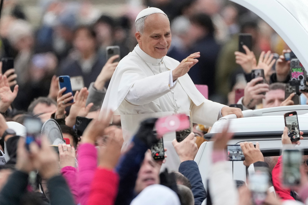 Pope Leo XIV waves before delivering the Urbi et Orbi (Latin for 'to the city and to the world' ) Christmas' day blessing from the main balcony of St. Peter's Basilica at the Vatican, Thursday, Dec. 25, 2025. (AP Photo/Gregorio Borgia)