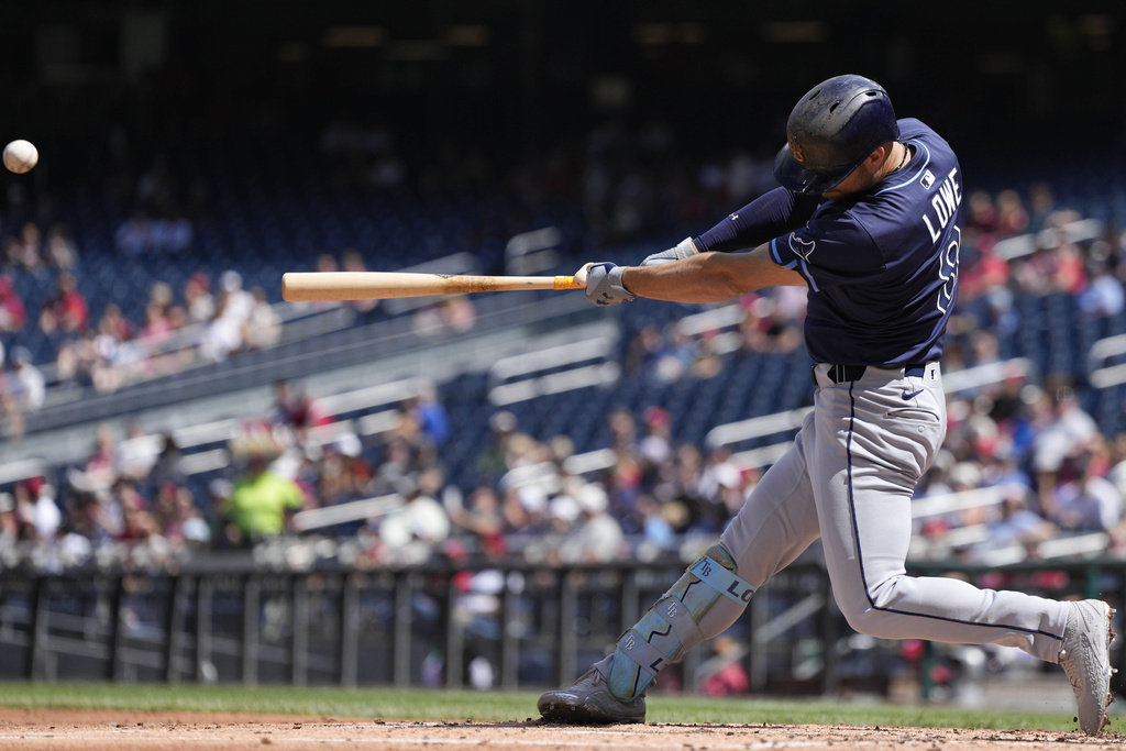 Tampa Bay Rays designated hitter Brandon Lowe hits a grand slam against the Washington Nationals during the second inning of a baseball game at Nationals Park, Sunday, Aug. 31, 2025, in Washington. (AP Photo/Jess Rapfogel)