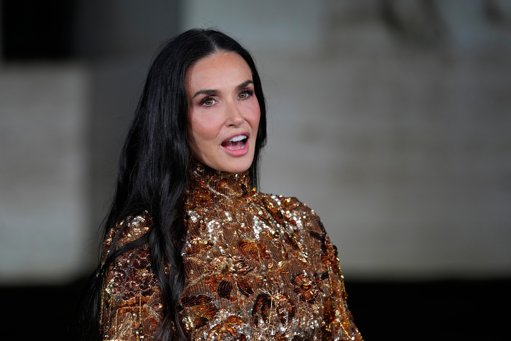 Demi Moore arrives for the premiere of the short film "The Tiger," directed by Spike Jonze and Halina Reijn, featuring the first looks by Gucci's new creative director, Demna, in Milan, northern Italy, Tuesday, Sept. 23, 2025. (AP Photo/Luca Bruno)