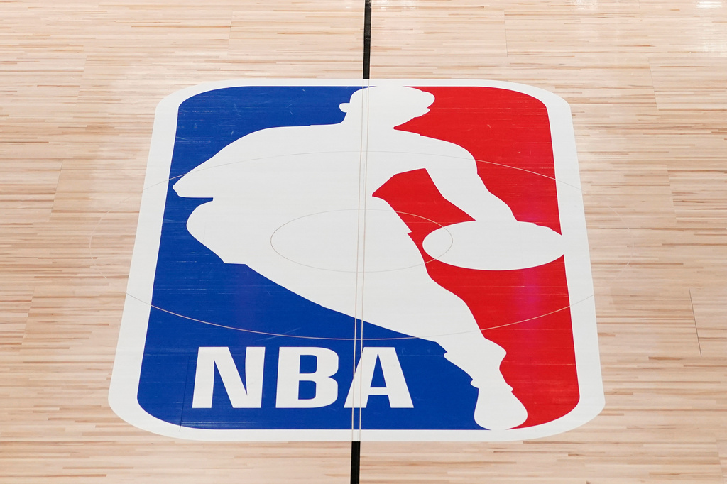 FILE - The NBA logo in shown on a basketball court in Lake Buena Vista, Fla., on Aug. 28, 2020. (AP Photo/Ashley Landis, Pool, File)