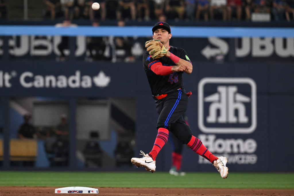 Toronto Blue Jays second baseman Luis Urias throws to first base to put out Chicago White Sox's Sam Antonacci during the first inning of a baseball game in Toronto, Friday, July 17, 2026. (Jon Blacker/The Canadian Press via AP)