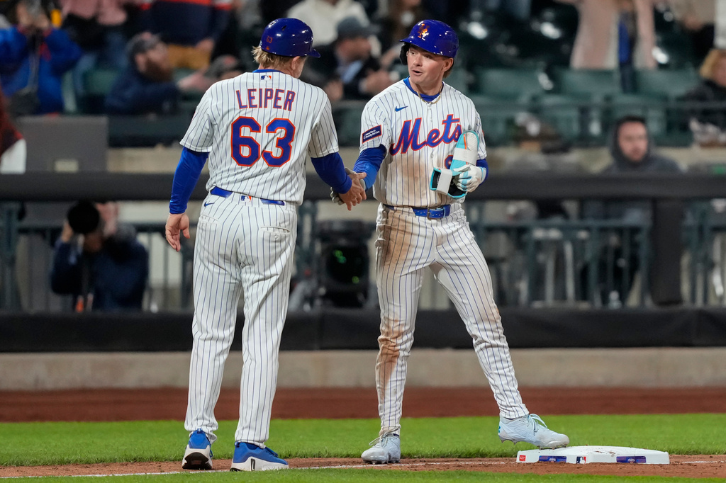 New York Mets' A.J. Ewing (9) celebrates with a teammate after hitting an RBI triple during the seventh inning of a baseball game against the Detroit Tigers, Tuesday, May 12, 2026, in New York. (AP Photo/Yuki Iwamura)