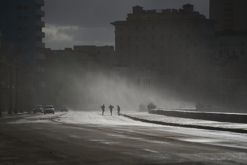 People walk along the Malecón in Havana, Monday, Feb. 23, 2026. (AP Photo/Ramon Espinosa)