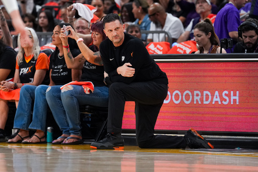 Phoenix Mercury Head Coach Nate Tibbetts takes a knee during the first half of Game 4 of a WNBA basketball playoff semifinals series against the Minnesota Lynx, Sunday, Sept. 28, 2025, in Phoenix. (AP Photo/Samantha Chow) Phoenix Mercury Head Coach Nate Tibbetts takes a knee during the first half of Game 4 of a WNBA basketball playoff semifinals series against the Minnesota Lynx, Sunday, Sept. 28, 2025, in Phoenix. (AP Photo/Samantha Chow)