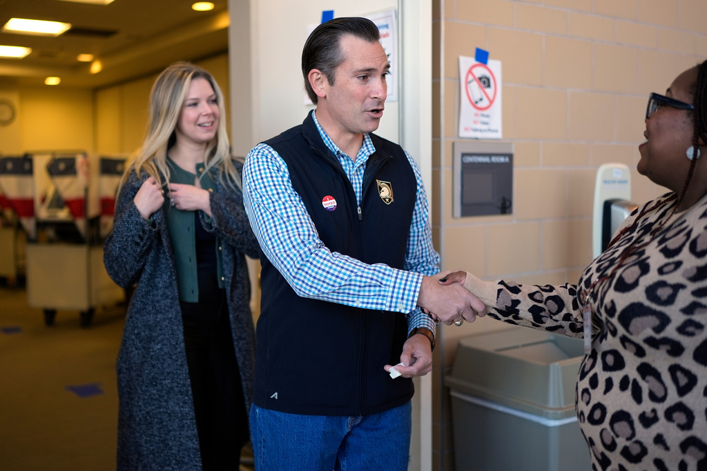 Republican congressional candidate Matt Van Epps, center, and his wife Meg Wrather, left, greet a poll worker after casting their ballots at an early voting site in the special election for the seventh district, Wednesday, Nov. 12, 2025, in Nashville, Tenn. (AP Photo/George Walker IV)