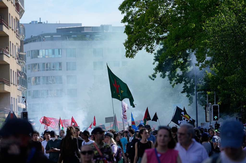 Protesters march during a "No G7" demonstration in Geneva, Switzerland, Sunday, June 14, 2026, ahead of the G7 summit scheduled to take place June 15-17. (AP Photo/Laurent Cipriani)