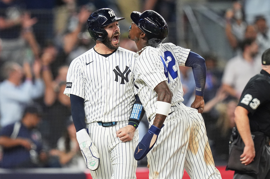 New York Yankees' Austin Wells, left, celebrates with Jazz Chisholm Jr. after they scored on a walk-off two run hit during the ninth inning of a baseball game against the Los Angeles Angels Wednesday, April 15, 2026, in New York. (AP Photo/Frank Franklin II)