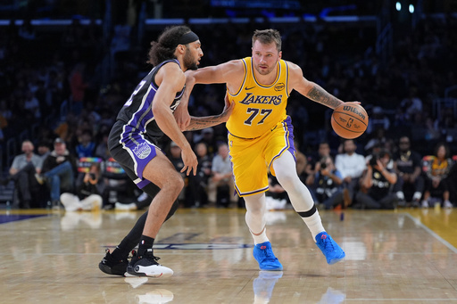 Los Angeles Lakers guard Luka Doncic (77) works around Sacramento Kings guard Devin Carter (22) during the first half of a preseason NBA basketball game Friday, Oct. 17, 2025, in Los Angeles. (AP Photo/Jae C. Hong) Los Angeles Lakers guard Luka Doncic (77) works around Sacramento Kings guard Devin Carter (22) during the first half of a preseason NBA basketball game Friday, Oct. 17, 2025, in Los Angeles. (AP Photo/Jae C. Hong)