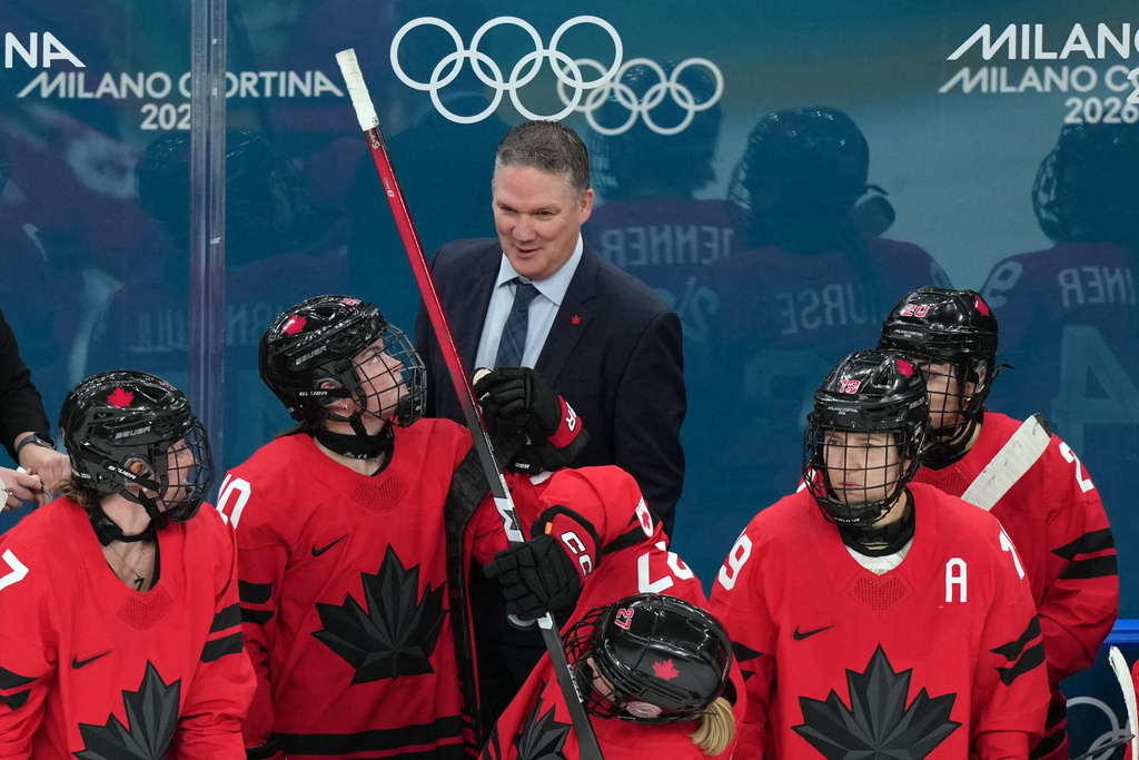 Canada head coach Troy Ryan talks with his players during the third period of a women's ice hockey semifinal match against Switzerland at the 2026 Winter Olympics, in Milan, Italy, Monday, Feb. 16, 2026. (AP Photo/Carolyn Kaster)