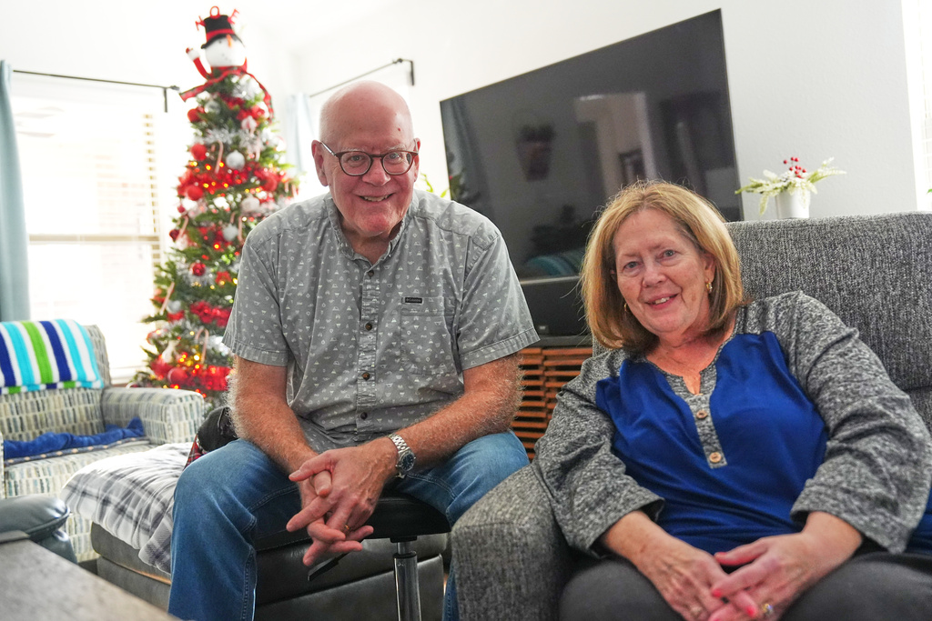 Chuck Dietrick, left, and his wife, Lori Dietrick, sit for a portrait at their home in Anna, Texas, Thursday, Dec. 18, 2025. (AP Photo/LM Otero)