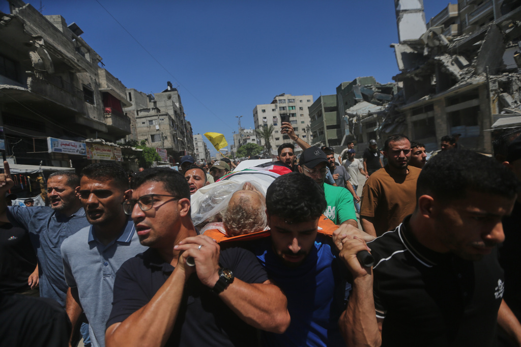 Palestinians carry the body of Mohamed al-Wahidi, director of public relations for the Egyptian Committee in Gaza, who was killed in an Israeli military strike, during his funeral in Gaza City, Wednesday, July 8, 2026. (AP Photo/Yousef Al Zanoun)