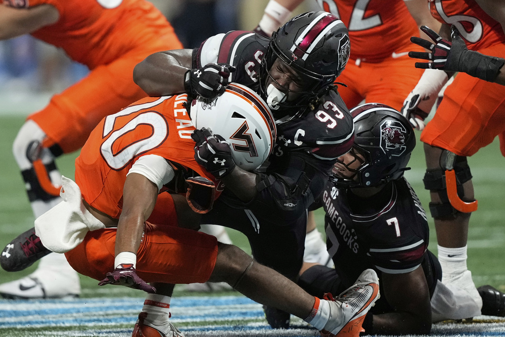 South Carolina defensive lineman Nick Barrett (93) tackles Virginia Tech running back P.J. Prioleau (20) during an NCAA college football game, Sunday, Aug. 31, 2025, in Atlanta. (AP Photo/Brynn Anderson)