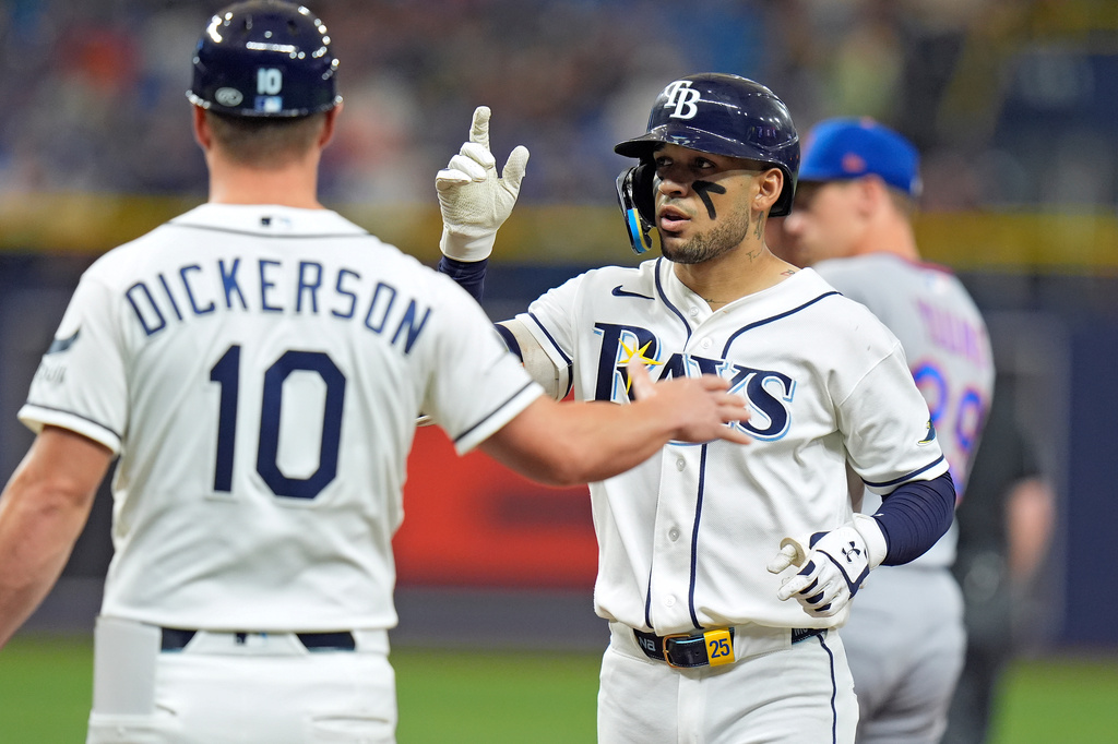 Tampa Bay Rays' Victor Mesa Jr., right, celebrates with first base coach Corey Dickerson after his single off New York Mets pitcher Sean Manaea during the fourth inning of a baseball game Tuesday, Sept. 1, 2026, in St. Petersburg, Fla. (AP Photo/Chris O'Meara)