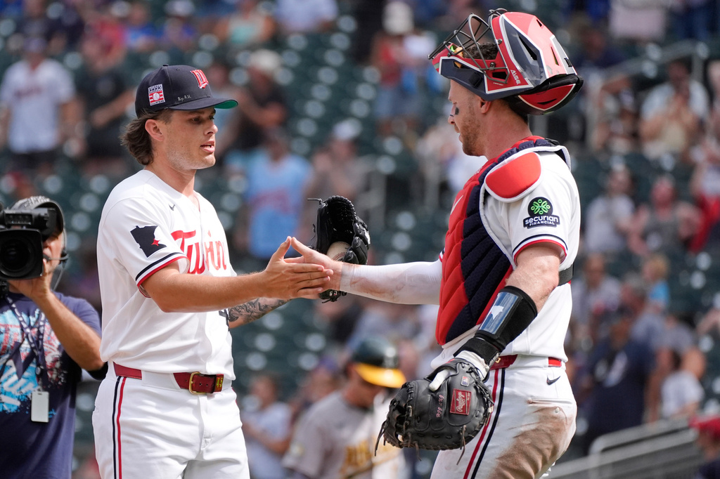 Minnesota Twins relief pitcher Travis Adams, left, celebrates with catcher Ryan Jeffers, right, after a baseball game against the Athletics, Sunday, July 26, 2026, in Minneapolis. (AP Photo/Bruce Kluckhohn)