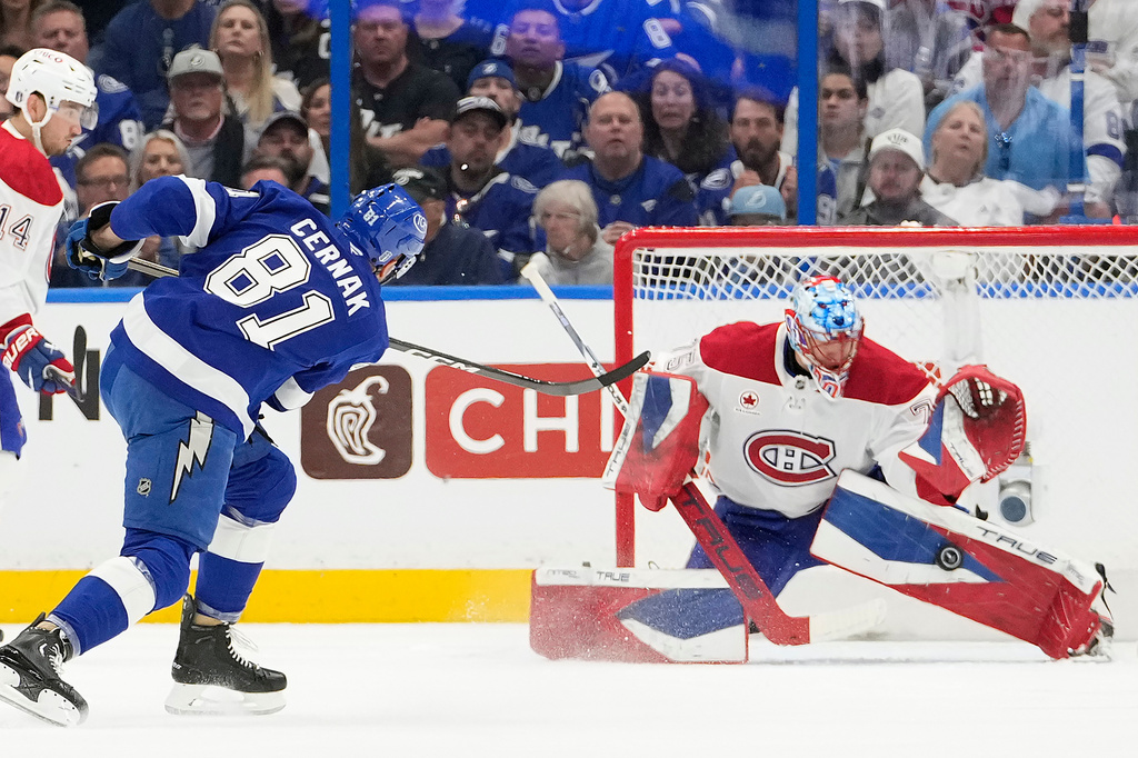 Montréal Canadiens goaltender Jakub Dobes (75) makes a save on a shot by Tampa Bay Lightning defenseman Erik Cernak (81) during the first period in Game 1 of an NHL hockey Stanley Cup first-round playoff series, Sunday, April 19, 2026, in Tampa, Fla. (AP Photo/Chris O'Meara)