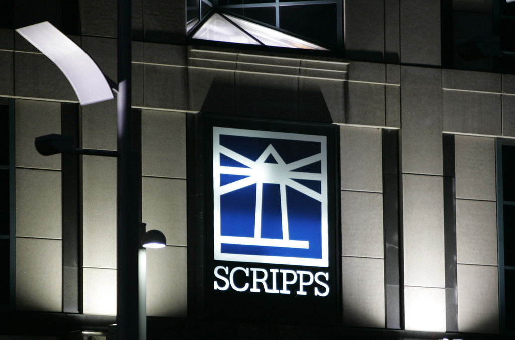 FILE - Floodlights light up the E.W. Scripps logo on the company's headquarters in Cincinnati, Jan. 31, 2006. (AP Photo/Al Behrman, File)