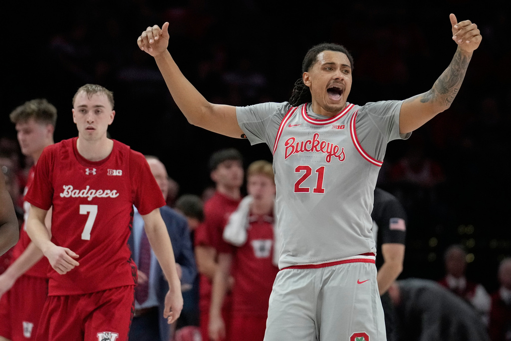 Ohio State forward Devin Royal (21) gestures in front of Wisconsin guard Andrew Rohde (7) in the first half of an NCAA college basketball game Tuesday, Feb. 17, 2026, in Columbus, Ohio. (AP Photo/Sue Ogrocki)
