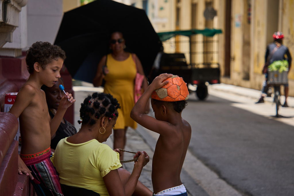 People spend time outside during a blackout in Havana, Cuba, Tuesday, July 14, 2026. (AP Photo/Ramon Espinosa)