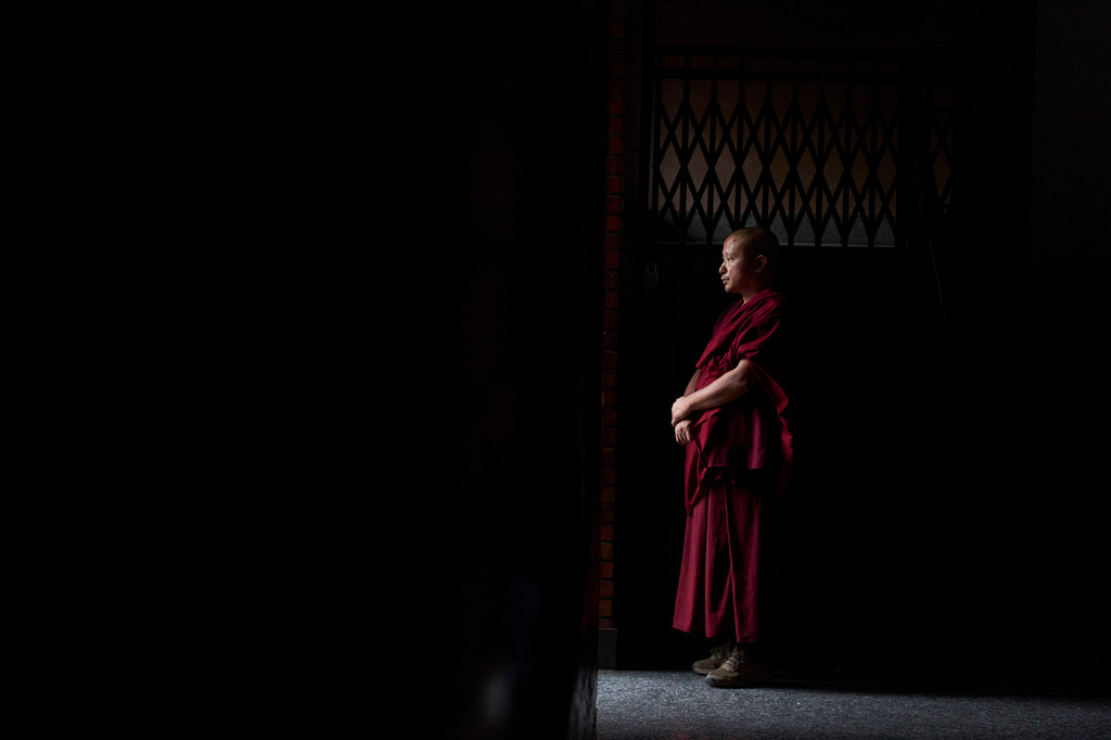 A Tibetan monk watches the cultural show, unseen, during the 91st birthday celebration of spiritual leader the Dalai Lama in Kathmandu, Nepal, Monday, July 6, 2026. (AP Photo/Niranjan Shrestha)