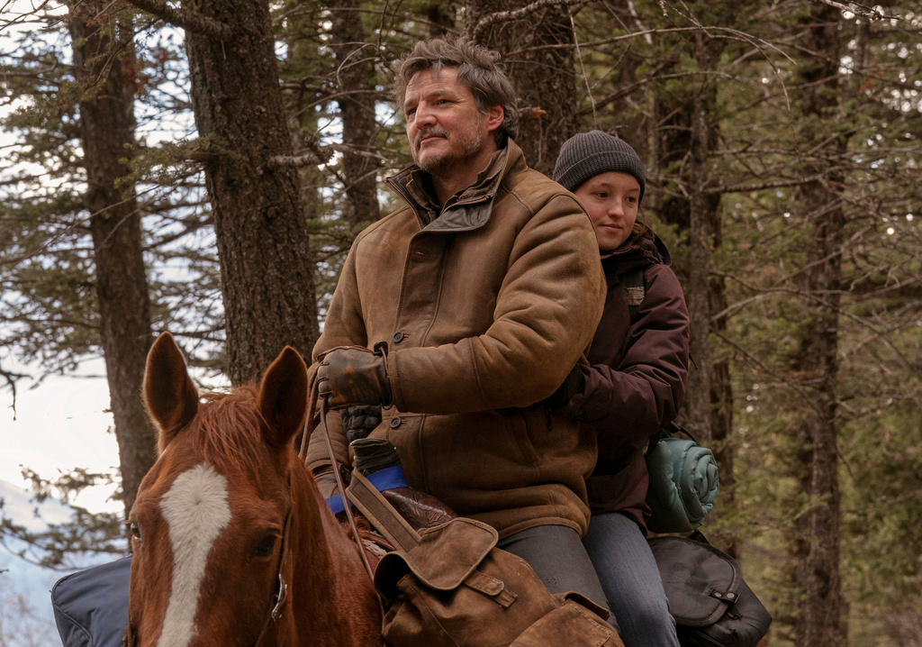 This image released by HBO shows Pedro Pascal, left, and Bella Ramsey in a scene from "The Last of Us." (HBO via AP)