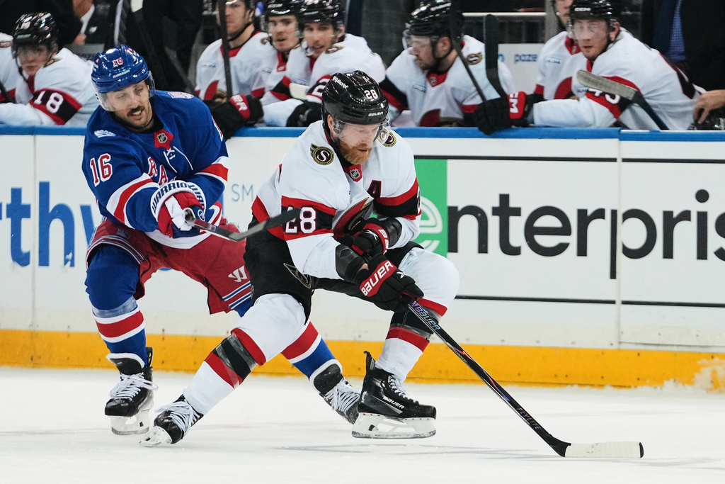 Ottawa Senators' Claude Giroux (28) drives past New York Rangers' Vincent Trocheck (16) during the second period of an NHL hockey game Monday, March 23, 2026, in New York. (AP Photo/Frank Franklin II)