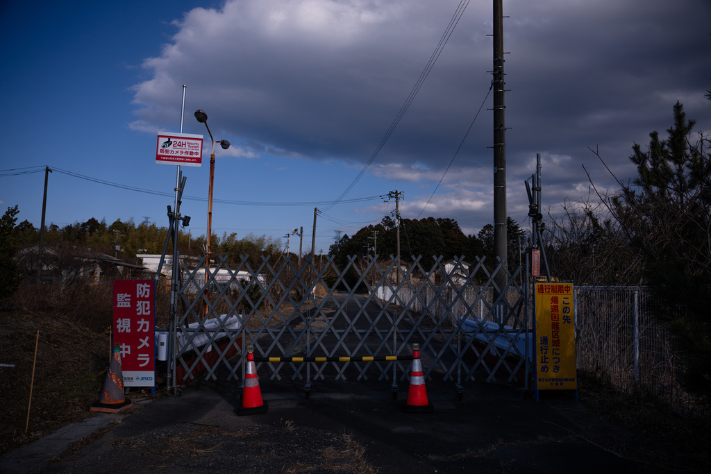 A fence blocks access to a restricted area designated as a 'difficult-to-return-zone' following the 2011 Fukushima Daiichi nuclear disaster in the coastal area of Fukushima prefecture, Friday, Feb. 13, 2026. (AP Photo/Louise Delmotte)