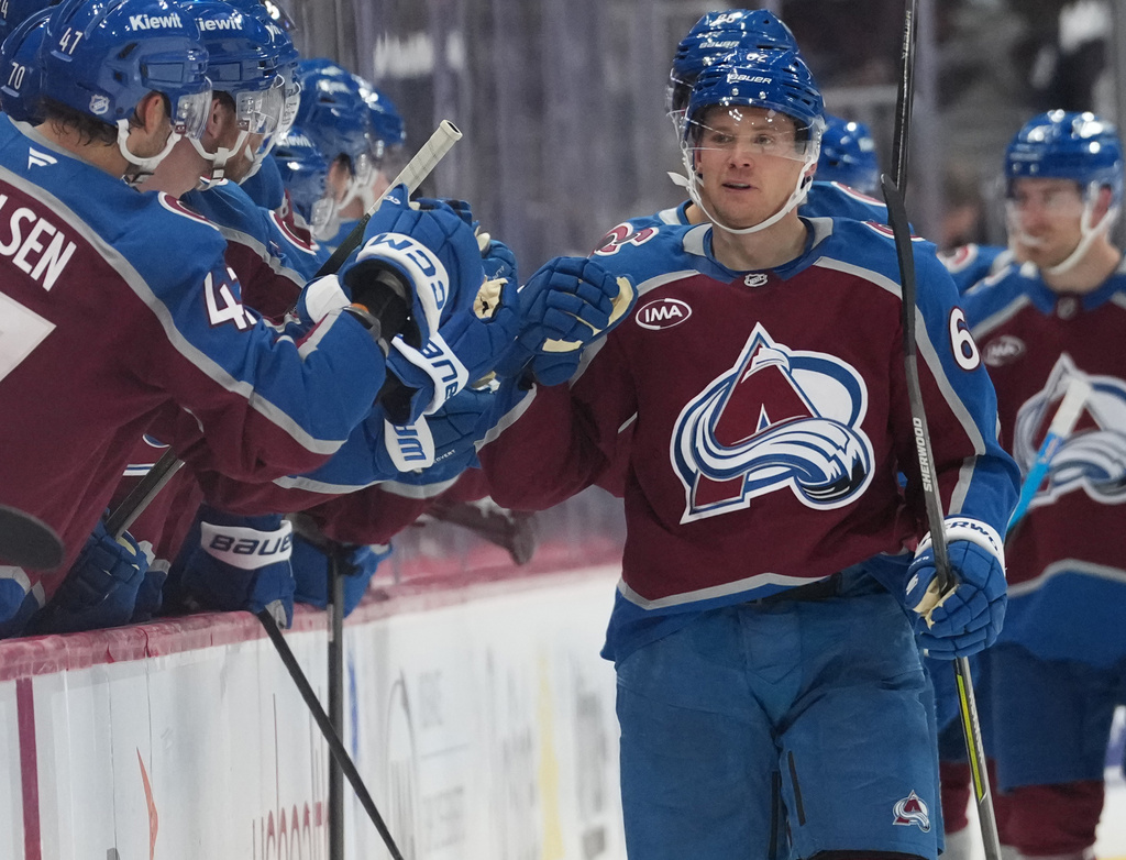 Colorado Avalanche left wing Artturi Lehkonen is congratulated as he passes the team box after scoring a goal against the Pittsburgh Penguins in the second period of an NHL hockey game, Friday, Oct. 16, 2026, in Denver. (AP Photo/David Zalubowski)