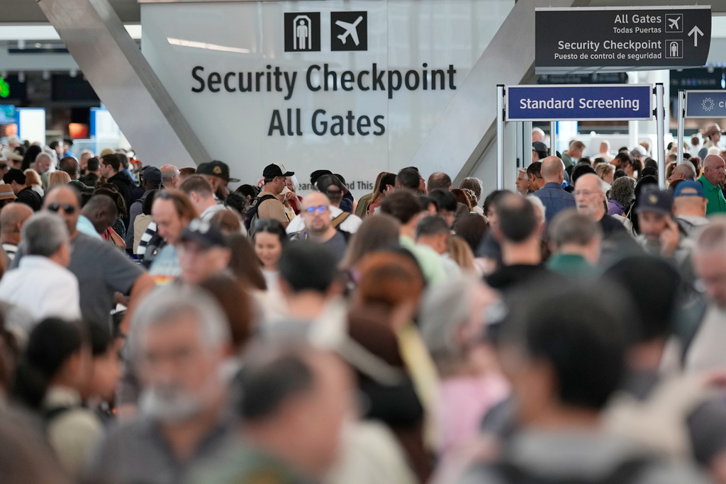 Passengers wait in a security checkpoint line at George Bush Intercontinental Airport, Wednesday, March 25, 2026, in Houston. (AP Photo/David J. Phillip)
