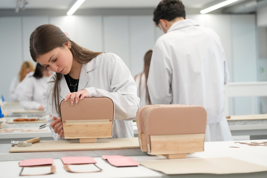 Leather good trainees work at the Prada factory in Scandicci, Italy, Friday, Nov. 28, 2025. (AP Photo/Gregorio Borgia)