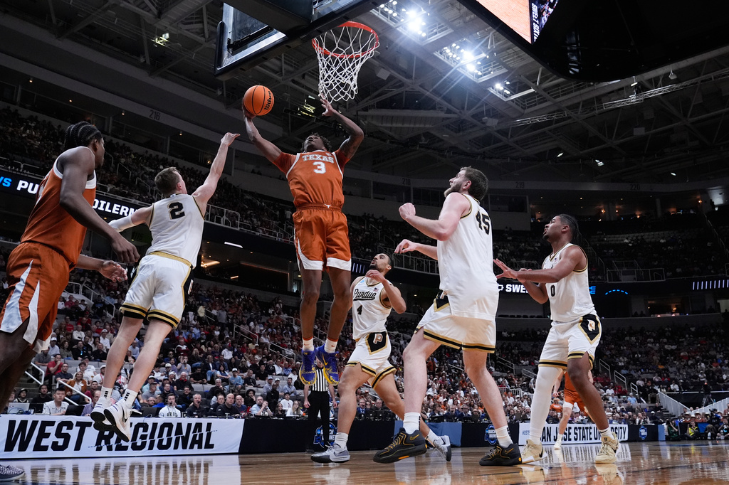 Texas forward Dailyn Swain (3) drives to the basket during the first half in the Sweet 16 of the NCAA college basketball tournament against Purdue, Thursday, March 26, 2026, in San Jose, Calif. (AP Photo/Godofredo A. Vásquez)