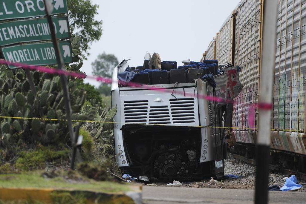 Wreckage of a double-deck bus lies next to a freight train that hit it in Atlacomulco, Mexico, Monday, Sept. 8, 2025. (AP Photo/Fernando Llano)