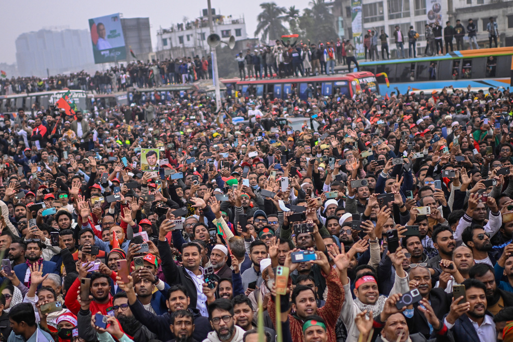Supporters of Bangladesh Nationalist Party (BNP) Acting Chairman Tarique Rahman shout slogans following his arrival at Hazrat Shahjalal International Airport in Dhaka after more than 17 years of self-imposed exile in London, Thursday, Dec. 25, 2025. (AP Photo/ Mahmud Hossain Opu)