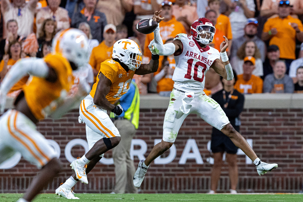 Arkansas quarterback Taylen Green (10) has the ball knocked from his hand by Tennessee defensive lineman Joshua Josephs (19) causing a fumble during the second half of an NCAA college football game Saturday, Oct. 11, 2025, in Knoxville, Tenn. (AP Photo/Wade Payne)