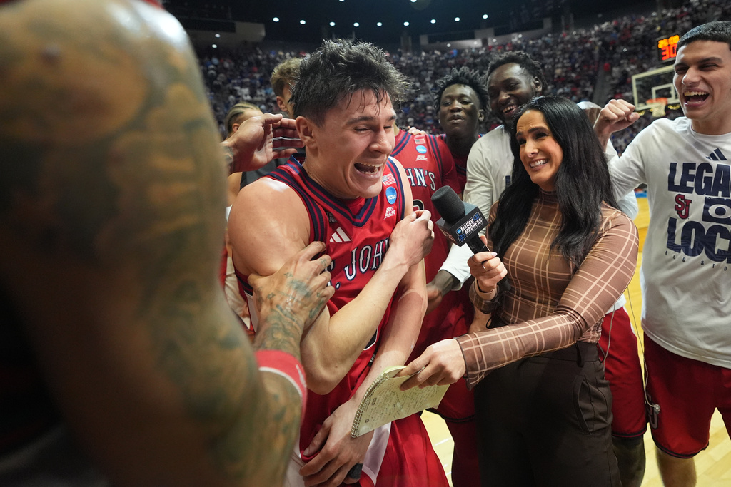 St. John's guard Dylan Darling (0) celebrates with teammates after defeating Kansas a game in the second round of the NCAA college basketball tournament Sunday, March 22, 2026, in San Diego. (AP Photo/Marcio Jose Sanchez)