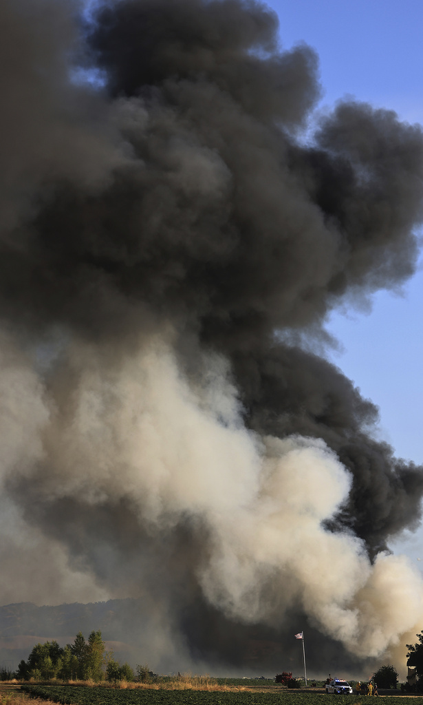 FILE - Smoke and flames rise during a fireworks warehouse explosion near Esparto, Calif., Tuesday, July 1, 2025. (Kent Porter/The Press Democrat via AP, File)