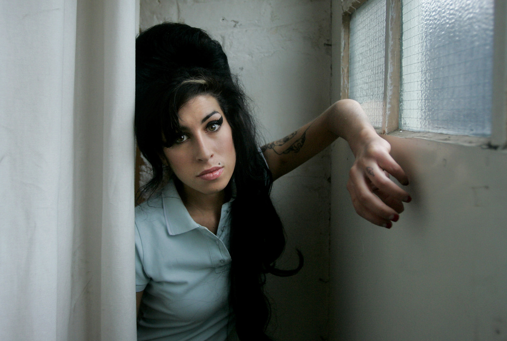 FILE - British singer Amy Winehouse poses for photographs after being interviewed by The Associated Press at a studio in north London, Friday, Feb. 16, 2007. (AP Photo/Matt Dunham, File)