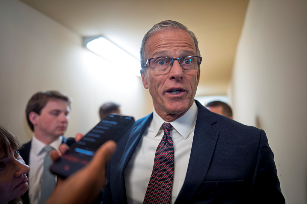 Senate Majority Leader John Thune, R-S.D., is met by reporters after a closed door meeting with fellow Republicans on the Homeland Security budget stalemate, at the Capitol in Washington, Thursday, March 26, 2026. (AP Photo/J. Scott Applewhite)